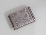 a small silver cigarette case sitting on a white surface