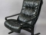 a black leather recliner chair with a black metal frame
