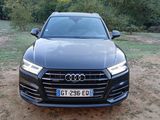 the front of a black audi suv parked on a dirt road