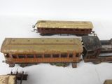 several toy trains are lined up on a white surface