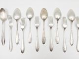 a lot of silver spoons and forks on the table
