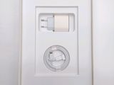 an apple iphone charger in a white box on a white surface