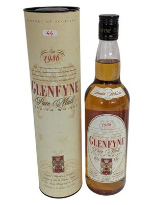 a bottle of gleneyne single malt whisky next to a cardboard box