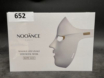 a box with a white mask on it on a table