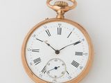 an old gold pocket watch with roman numerals and roman numerals on the face