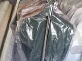 a lot of clothes on a cart in the living room