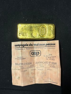 a piece of paper with a piece of gold on it
