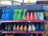 many different colored vases on the shelves in the store