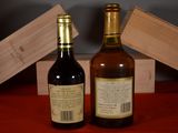 two bottles of wine sitting next to each other on a table