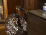 a statue of a dog that is sitting on a table