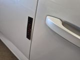 a close up of a door handle on a white car