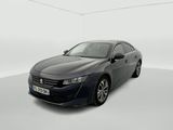a grey car is parked in a white room with a white floor