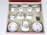 a box that has a set of tea cups and saucers in it