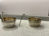 pair of silver plated serving bowls with spoons and tongs