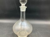 an image of a clear glass bottle sitting on top of a counter