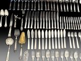 an assortment of silverware including forks, spoons, and knives