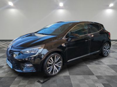 a black car parked on a checkered floor in a garage