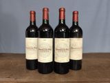 three bottles of wine sitting on top of a wooden table