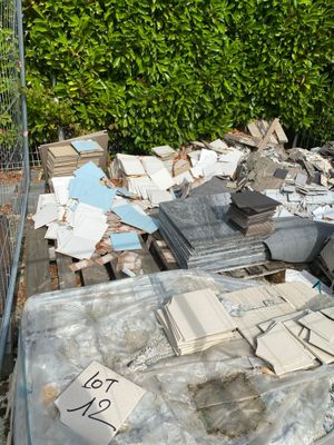 a pile of junk sitting on the ground next to a fence
