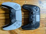 two video game controllers that are sitting on a table