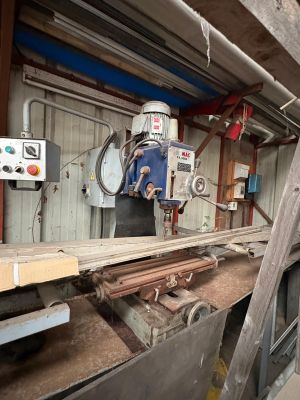 a machine that is working on a piece of wood