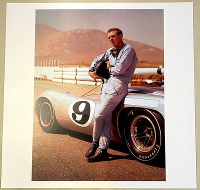 a picture of a man leaning on a car