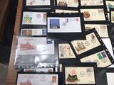 a lot of stamps on a table with a black binder