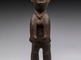 an image of a statue of a man standing on a black base