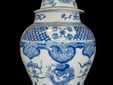 a large blue and white vase with a bird on it