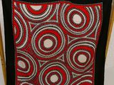 an image of a black and red scarf hanging on a clothes rack
