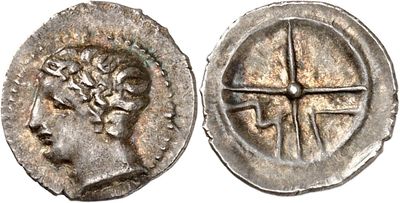 a silver coin with an image of a woman and a cross on it