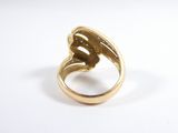 an image of a gold ring on a white surface
