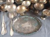 a lot of silver spoons and spoons on a table