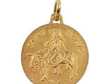 a close up of a gold coin with a horse and rider on it