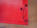 a red table with a black design on it