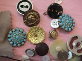 many different buttons and buttons on a pink surface
