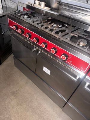 a stove with a pot on top of it in a kitchen