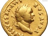 a close up of a gold coin with an image of a man on it