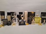 several bottles of perfume are lined up on a white surface