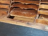 many wooden drawers that are stacked on top of each other