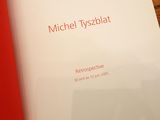 a book with a red cover on a wooden table