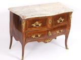 an antique chest of drawers with marble top and brass handles