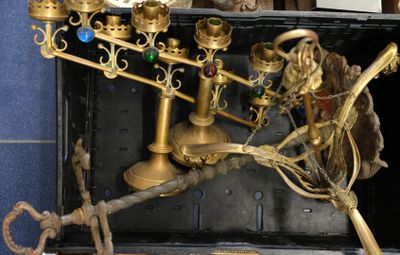 a gold menorat with a clock on top of it