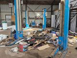 a picture of a garage with a lot of junk on the floor