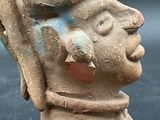 a clay statue of a man with a hat on