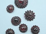 several pieces of garnets are arranged on a white surface