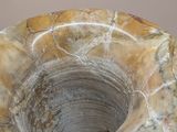a marble bowl sitting on top of a wooden table