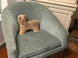 a teddy bear that is sitting in a chair