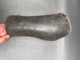 a hand that is holding a large piece of metal