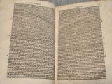a close up of an open book with writing on it